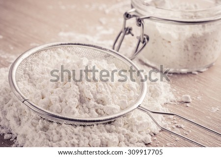 Flour in sieve and glass jar, filtered image