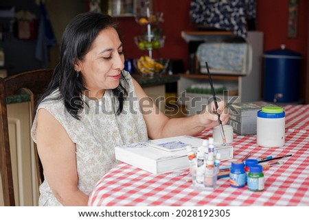 Similar – Image, Stock Photo Older woman painting on a notebook