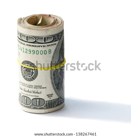 Roll of American one hundred dollar bills bundled with a thin yellow rubber band.