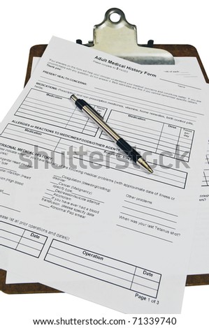 Medical history forms on a clipboard with two small pills sitting on the form with a pen. Isolated on white with a clipping path