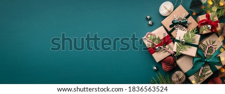 Similar – Image, Stock Photo Christmas background. Red table cloth with town of cute gingerbread houses decorated with icing, Christmas lights, glitter. Holiday mood.