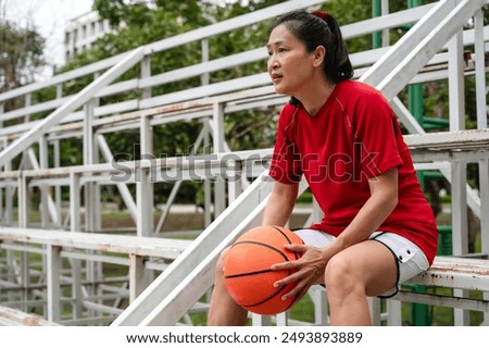 Similar – Image, Stock Photo Tired sportswoman with basketball ball resting on court