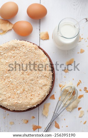 Mille-feuille cake in vintage provence style background with milk, eggs and lavender. Top view