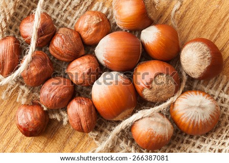 Heap of hazelnuts healthy seasonal vegetarian snack in nutshell natural food on wooden background