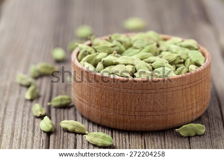Green cardamom super food ayurveda asian aroma spice flavour in a wooden bowl on vintage background