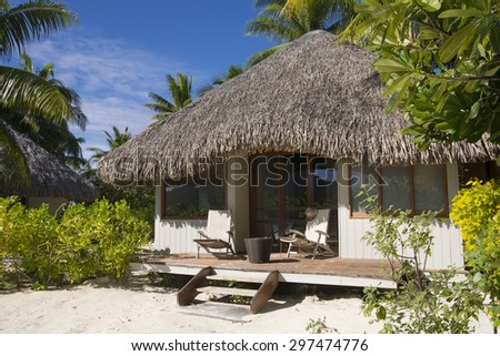 Beach bungalow with deck chairs on a tropical island, Bora Bora, near Tahiti, French Polynesia, Pacific ocean