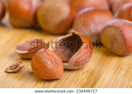 Hazelnut or filbert kernel and its shell on old wooden background