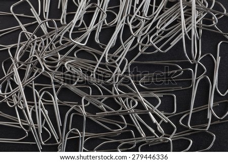 metal paper clips on a black background