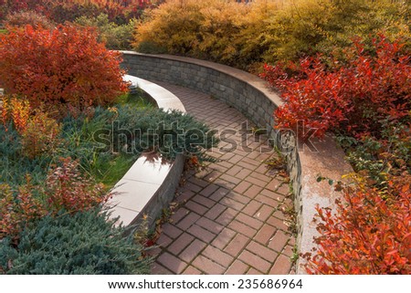 Autumn in the park, a path among autumn flower beds. Morozovsky garden in Moscow fragment