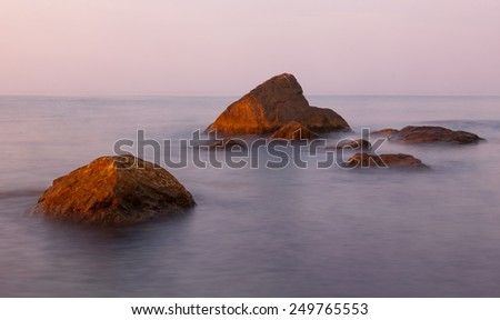 Seascape in the early morning with stones and rocks in the minimalist style. Black Sea, Crimea