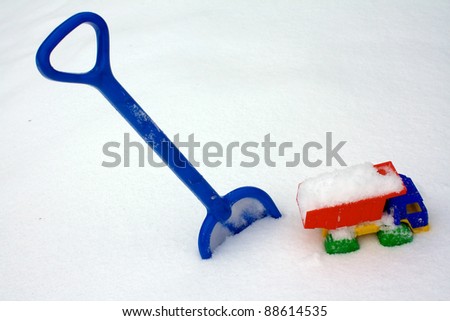 Child\'s shovel and truck in to snow