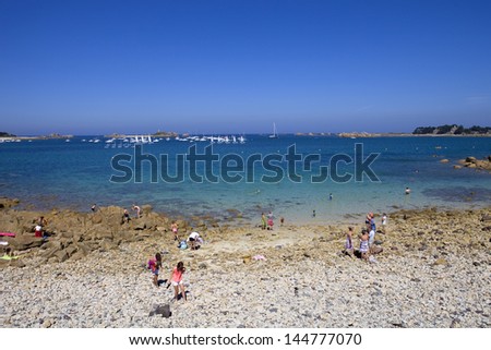PORT-BLANC, BRITTANY, FRANCE - AUGUST 10: People at the beach, on August 10, 2012 in Port-Blanc, Brittany, France.