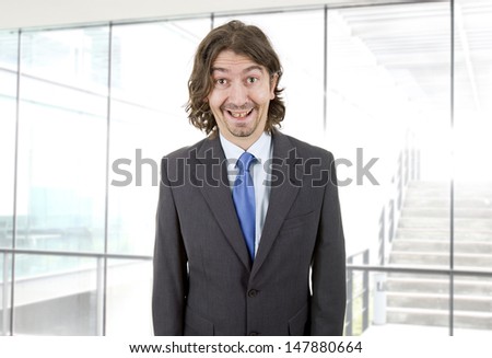 happy young businessman with silly face at the office