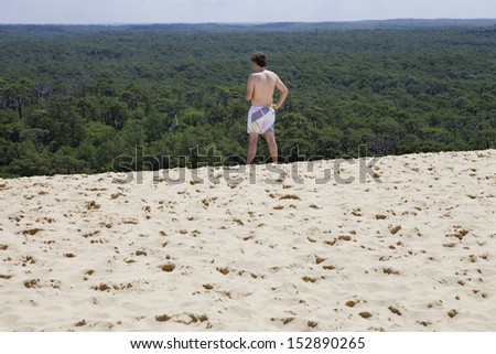 PYLA SUR MER, FRANCE - AUGUST 8: A man visits Famous dune of Pyla, the highest sand dune in Europe, on August 8, 2012 in Pyla Sur Mer, France.