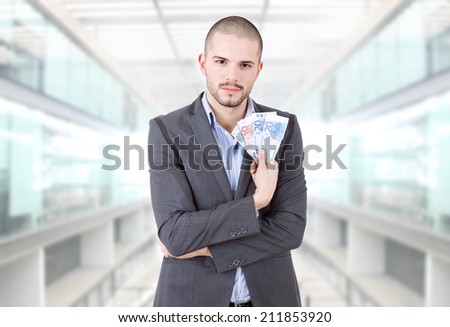 young casual man with lots of money at the office