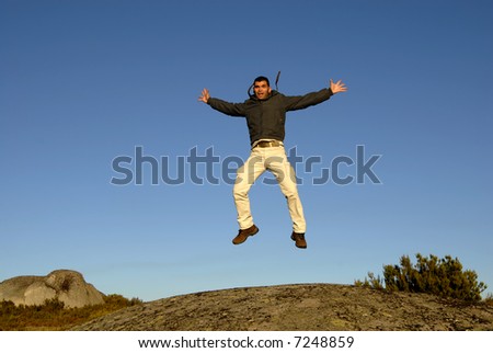young man jumps high in the mountain