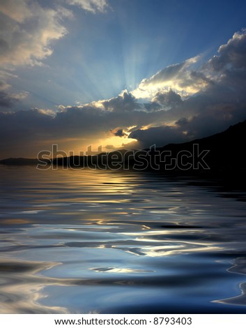 sunset over the mountains, with water reflection