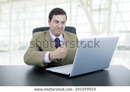 mad businessman working with is laptop, at the office