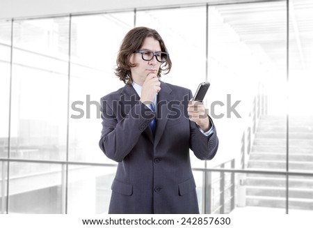 young business man looking worried to his phone, at the office