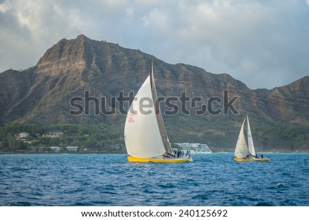 Honolulu, Dec. 26:  Racing sailboats rounding the Diamond Head Buoy on the Friday night sailboat races.  Honolulu, Hawaii, USA.  Dec. 26, 2014