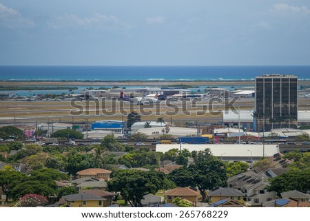 Honolulu, Hawaii, USA, April 1, 2015:  Honolulu H-1 afternoon traffic is at a stand still as Hawaiian Airlines departs runway 26 right on a clear afternoon.