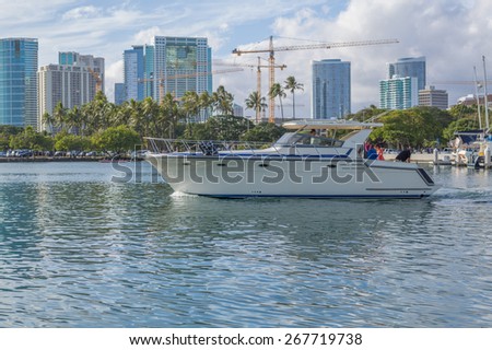Honolulu, Hawaii, USA, April 8, 2015:  Motorboat on a harbor cruise in Honolulu Hawaii inside the  Ala Wai Small Boat Harbor on a clear and calm morning.