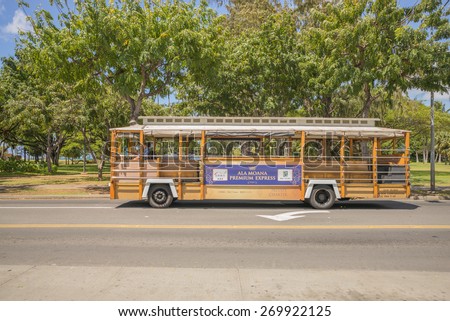 Honolulu, Hawaii, USA, April, 16, 2015: The vintage Waikiki Trolley continues to be the favorite means of transport around Waikiki and Honolulu: Waikiki Trolley serves all of Waikiki with schedules.