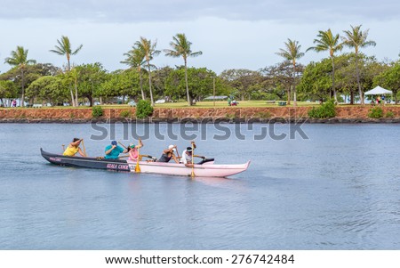 Honolulu, Hawaii, USA, May 11, 2015:  Mixed outrigger canoe team with both men and women out practicing for the upcoming canoe races in Waikiki.