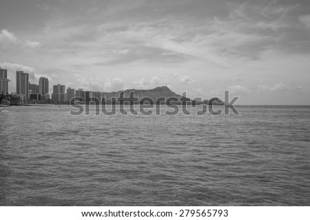 Honolulu, Hawaii, USA, May 20, 2015: Diamond Head and Waikiki resorts and hotels an early morning with water sport enthusiasts already out in the water. Waikiki is a world famous vacation destination.