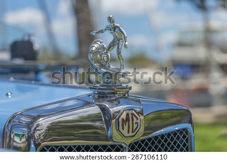 Honolulu, Hawaii, USA, June 13, 2015: Automobile hood ornament of a surfer riding a wave.