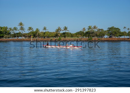 Honolulu, Hawaii, USA, June 28, 2015:  Dawn view of an outrigger canoe departing Waikiki\'s Ala Wai Harbor en route to an outer island destination. Outrigger canoes travel between the Hawaiian Islands.