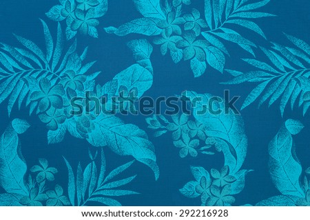 Polynesian background pattern/texture with light blue leaves and plumeria flowers against a faded  blue background.