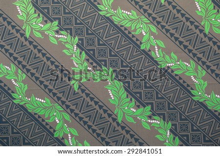 Faded Polynesian pattern/texture of green Maile Leis over a tattoo pattern on a brown background.