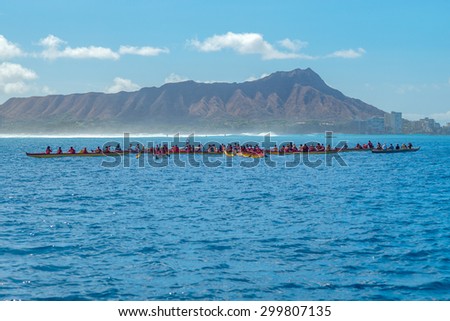 Honolulu, Hawaii, USA, July 25, 2015:  Noon view of Waikiki and Diamond Head as outrigger canoes gather for a scattering of ashes.  Large surf and spray made this a harder task.