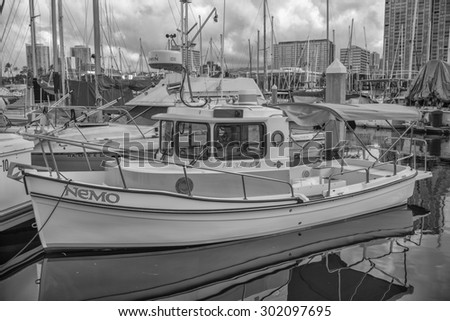 Honolulu, Hawaii, USA, August l, 2015:  Morning view of a miniature tug boat which is fully functional.  Miniature boats are becoming increasingly popular in Hawaii\'s Ala Wai Small Boat Harbor.