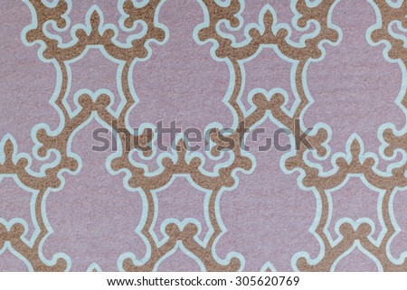 Vintage cloth fragment from a Hawaiian style aloha shirt with a faded golden design against a lavender/pink background.