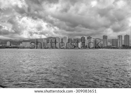 Honolulu, Hawaii, USA, August 24, 2015:  Morning view of Waikiki hotels and the Ala Wai Boat Harbor with unusual storm clouds above Honolulu.  Summer storms are infrequent in Honolulu.