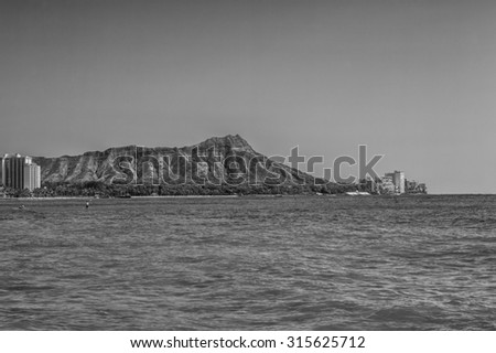 Honolulu, Hawaii, USA, Sept. 11, 2015:  Morning view of Diamond Head Crater and surrounding hotels with Waikiki beach and surf in the foreground.  Waikiki is a world class water sports destination.