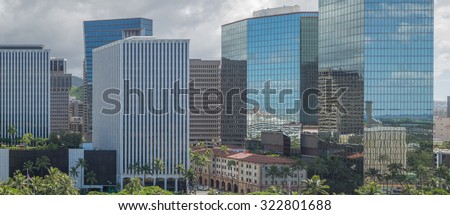 Honolulu, Hawaii, USA, Oct. 1, 2015:  The Financial District of Downtown Honolulu on a cloudy morning with Honolulu Harbor reflected in the many glass windows.  Honolulu is a banking center in Hawaii.