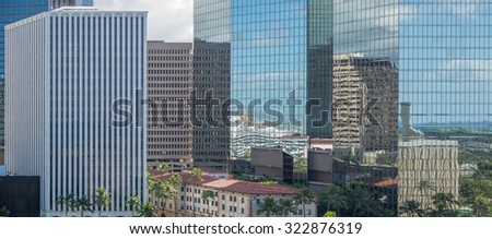 Honolulu, Hawaii, Oct. 1, 2015:  Panorama of the Honolulu Business District with Honolulu Harbor reflected in the building windows.  Honolulu is the business center for the Pacific islands.