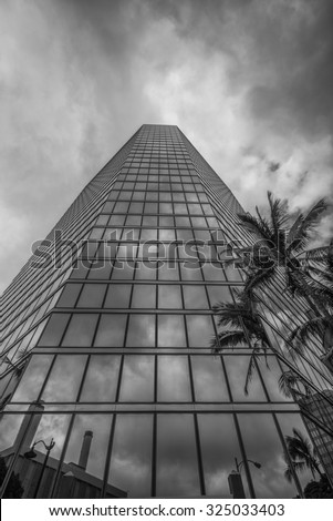 Honolulu, Hawaii, USA, Oct. 7, 2015:  Afternoon sunlight and clouds reflected in a modern glass building on Bishop Street in the Honolulu financial district.  Honolulu is Hawaii\'s financial center.