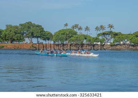 Honolulu, Hawaii, USA, Oct. 9, 2015:  Outrigger Canoe and team practicing paddling in the Ala Wai Canal.  Outrigger canoes are popular as a sport and as transportation in the Hawaiian Islands.