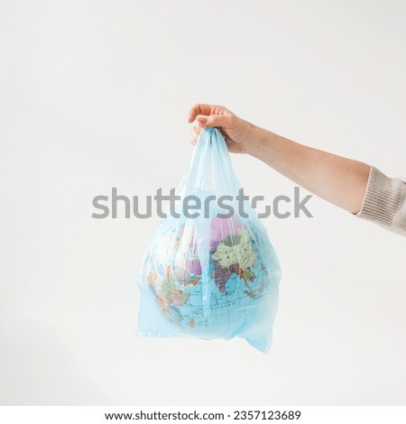 Similar – Image, Stock Photo Globe in a plastic bag. Earth contaminated by plastic waste