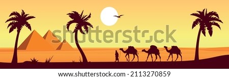 Camel caravan near the pyramids of Egypt. Panoramic landscape. Egyptian pyramids in the desert in the background.
