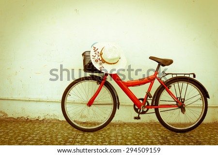 red bicycle on old dirty  house wall,vintage style.