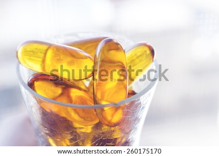 Pure cod liver oil with simple setup on clean lighting.