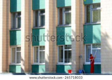 Window cleaning high-rise building - a blurred background