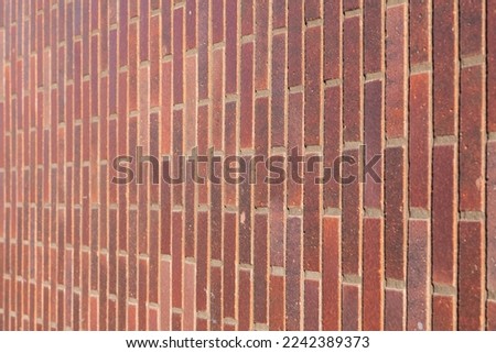 Dark brown redish bricks used in new modern architecture, the wall of an exterior residential home. Chique stylish trend in stone tiles and bricks creating a luxury feeling, horizontal selective focus Foto stock © 