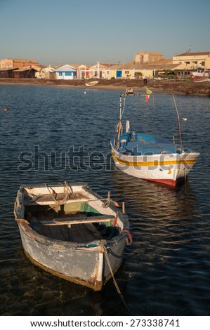 Fishing boats in the small harbor of the sea village Marzamemi, Southeast Sicily, in the early morning