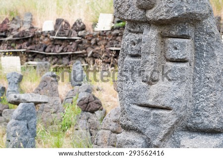 Grey lava stone sculpture of an old king